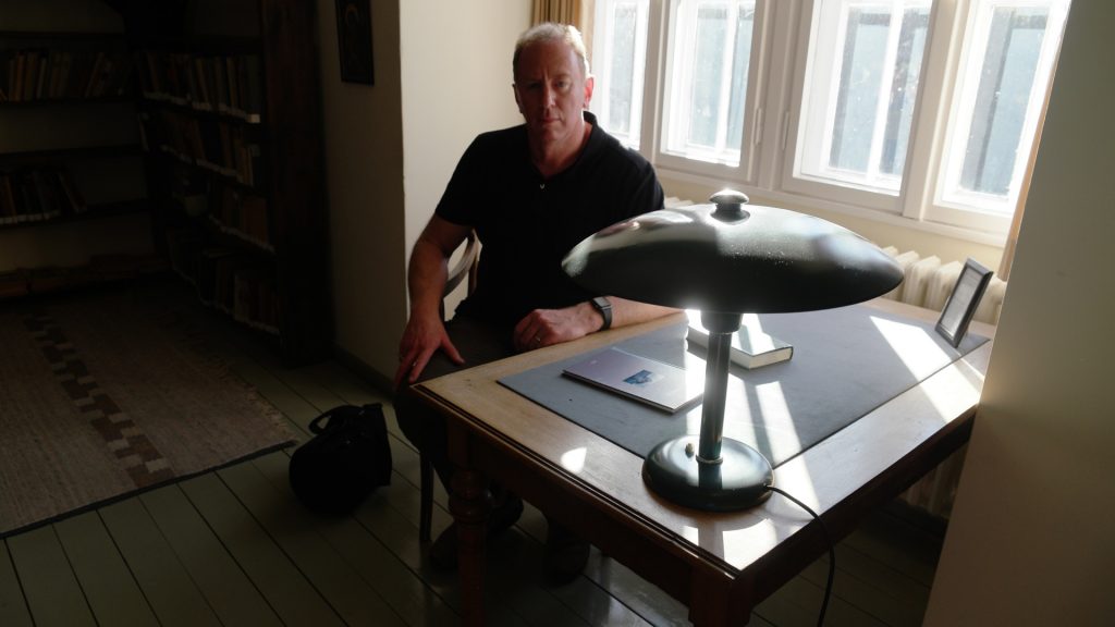 Andrew Corbett sitting at Dietrich Bonhoeffer's writing desk