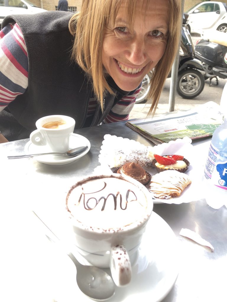 Kim about to enjoy an Italian coffee and pastry in Rome