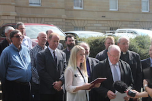 Clair Van Ryn presents the Salamanca Declaration to the Speaker of the House, My Michael Polley